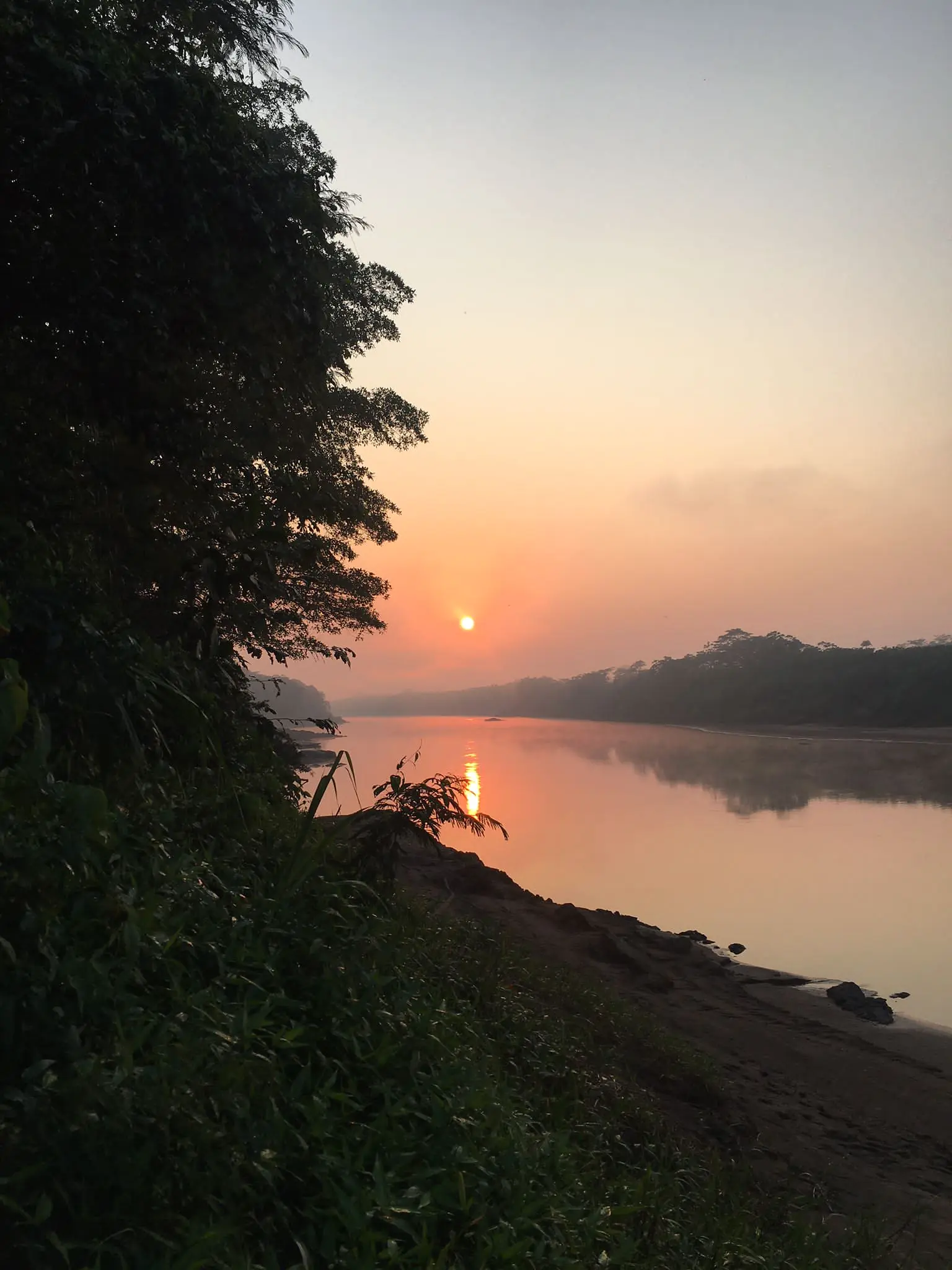 Sunrise glowing over a quiet Amazon River