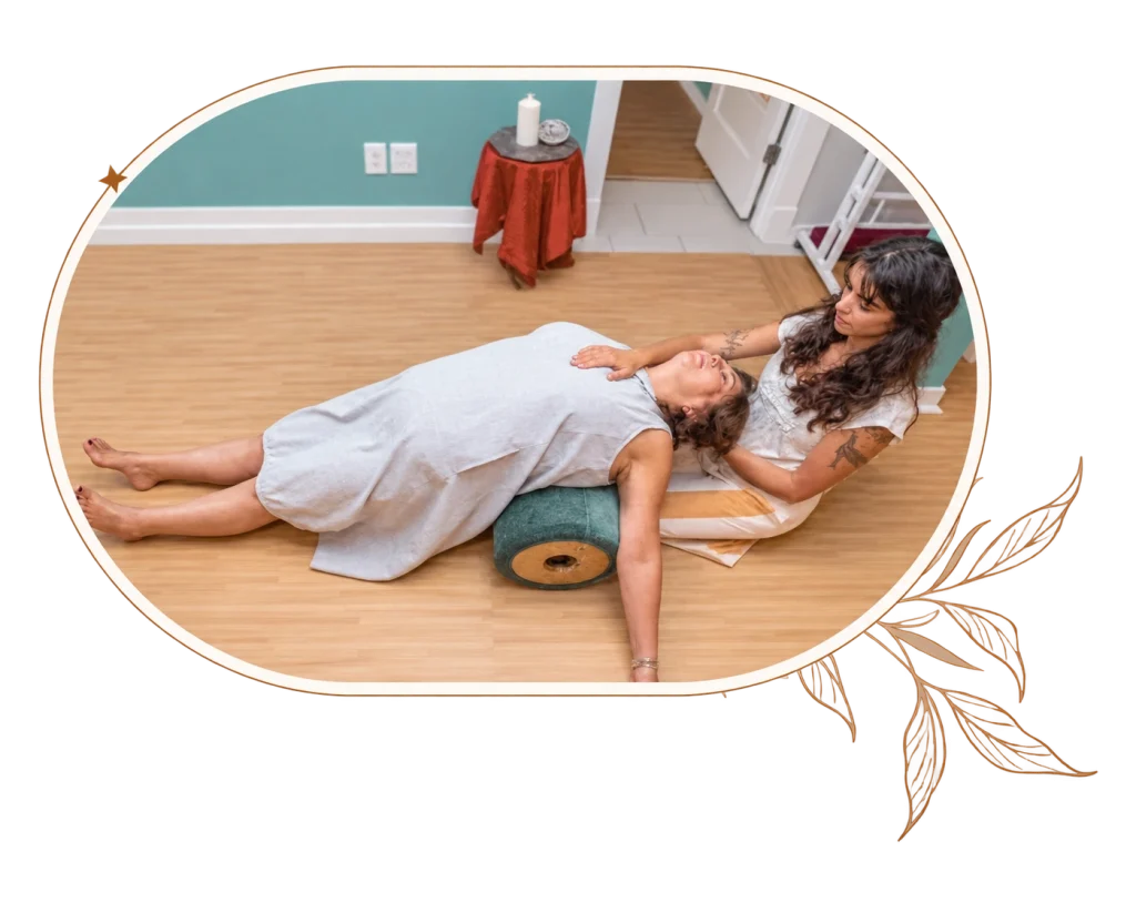 Sofia supporting a client during consensual, non-sexual somatic bodywork
