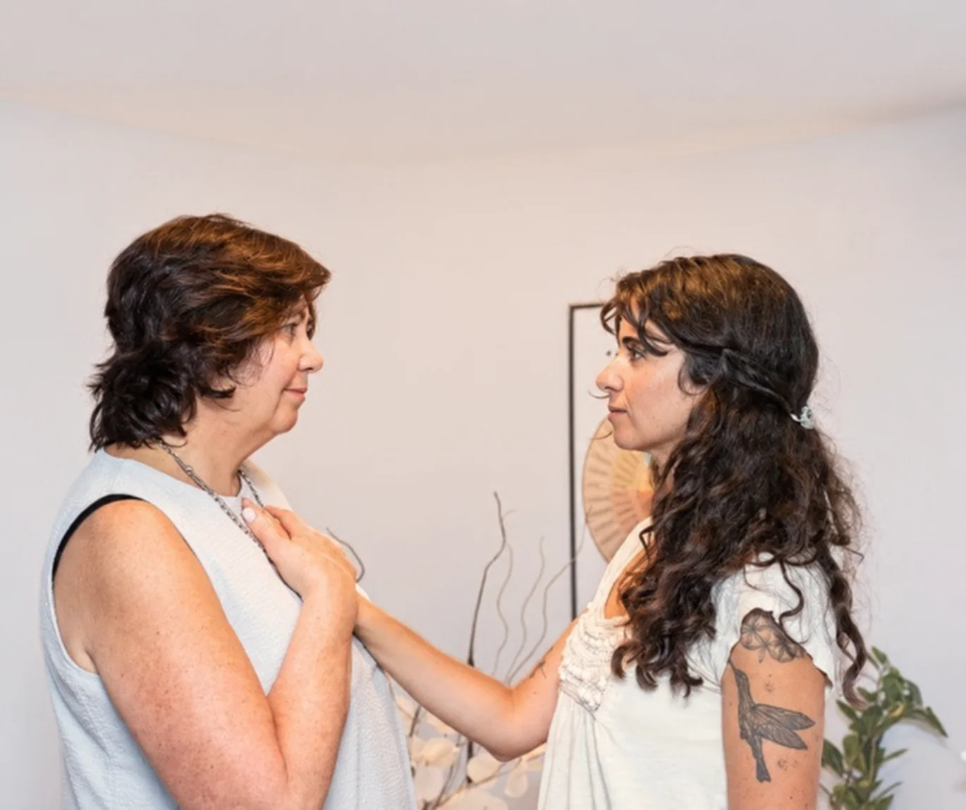 Sofia and a client sharing a hand-on-heart moment in session