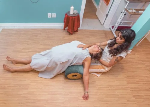 Sofia supporting a client lying on a roller during body-centered work